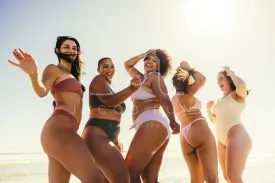 Carefree friends dancing at the beach