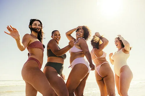 Carefree friends dancing at the beach